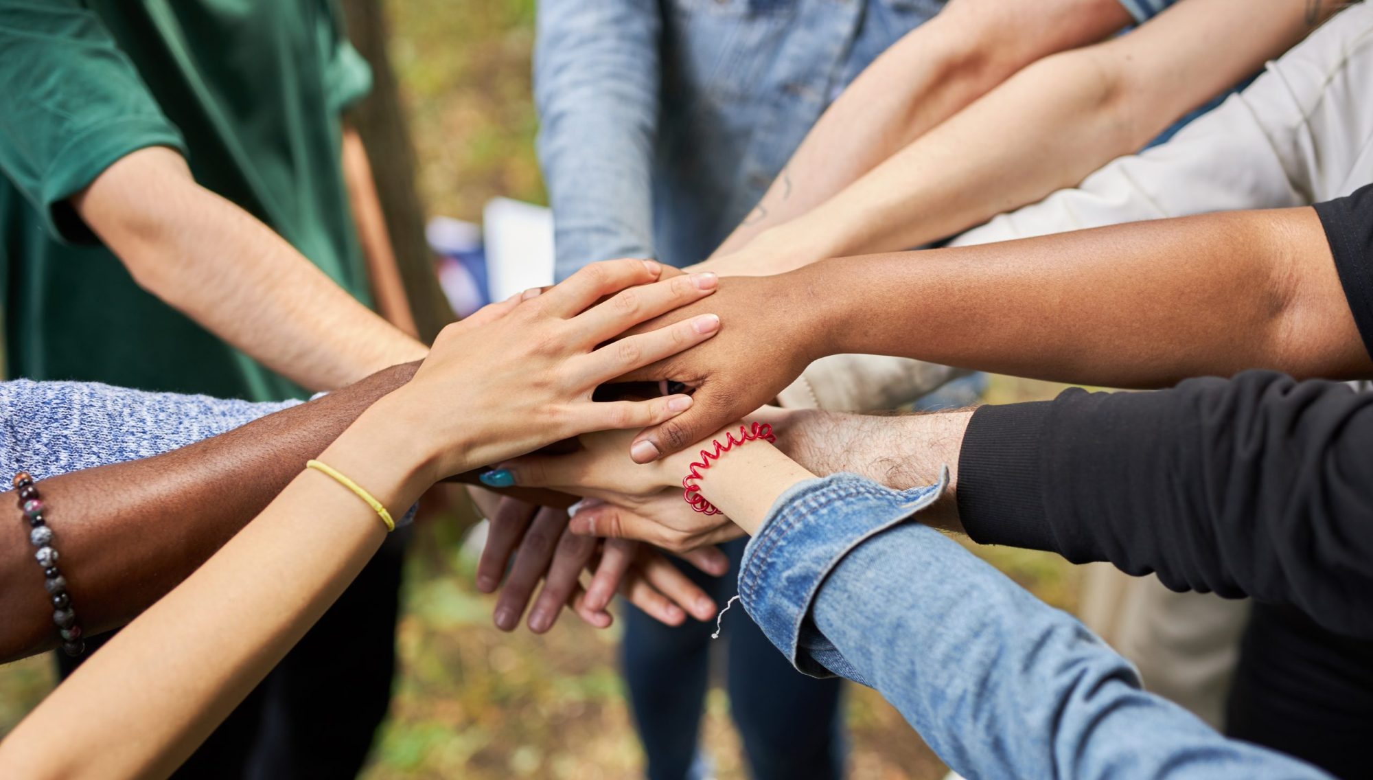 close-up photo of diverse people's hands gathered together