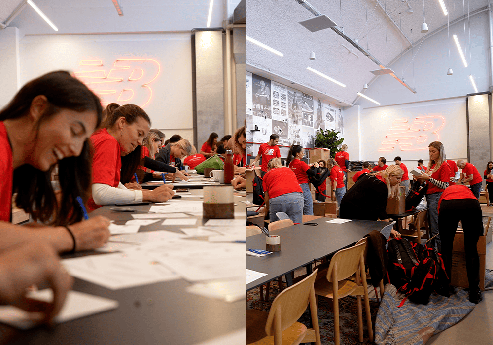 New Balance employees engaging in a volunteer event, packing and writing cards at tables decorated with the company's logo.