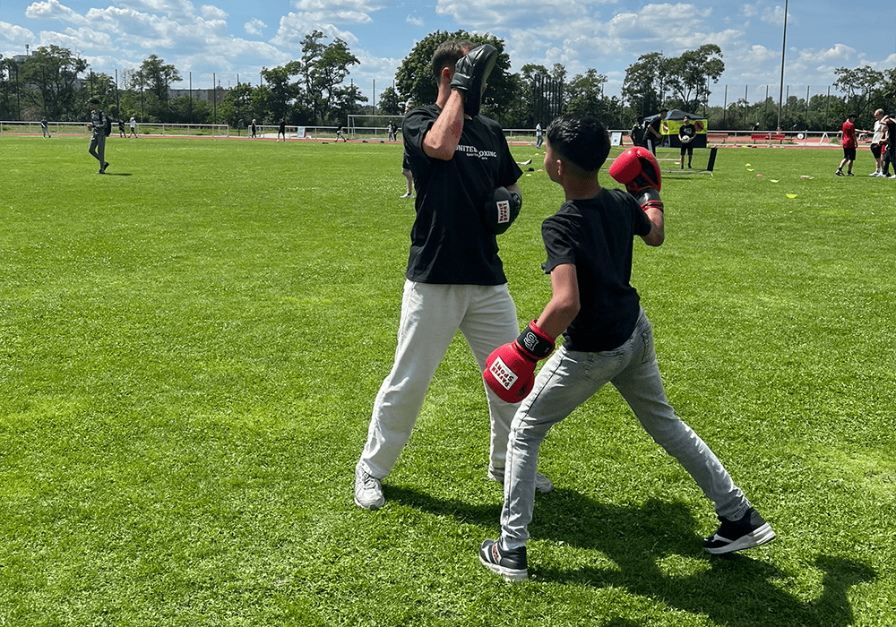 Young person practicing boxing on a field