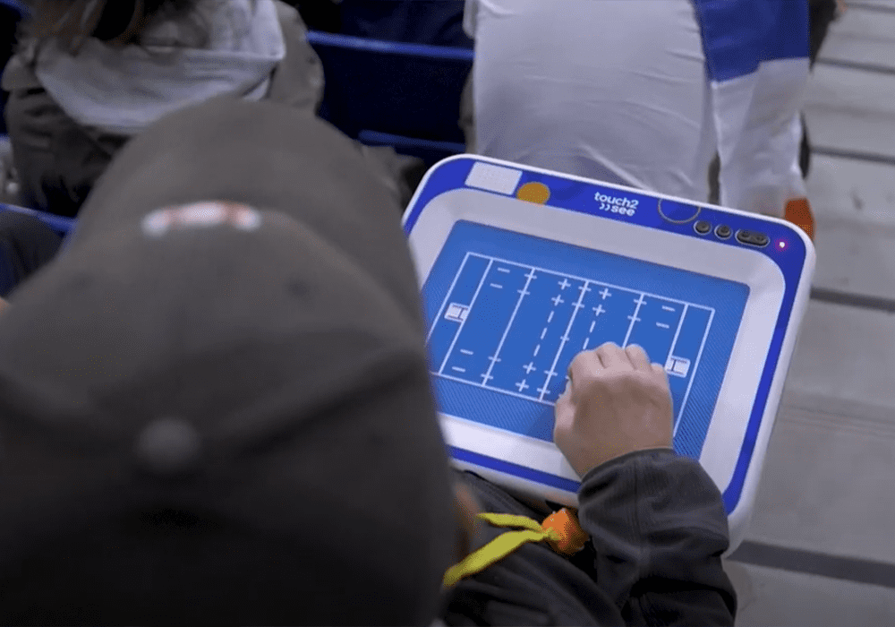 A person using a touch2see tablet during the 2023 Rugby World Cup. 